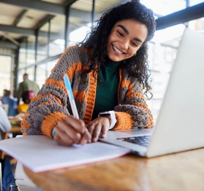 young woman taking notes on association trends