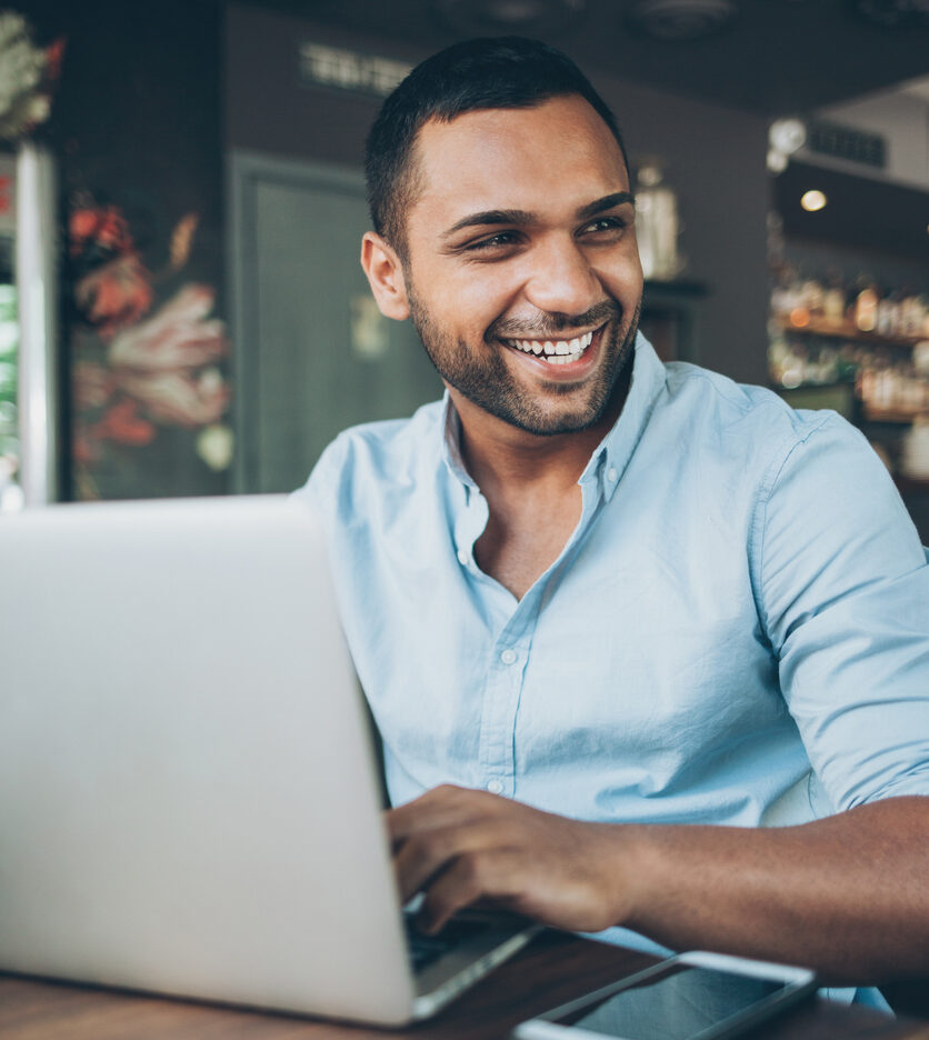 woman community manager with blue hair working on community management strategies on laptop