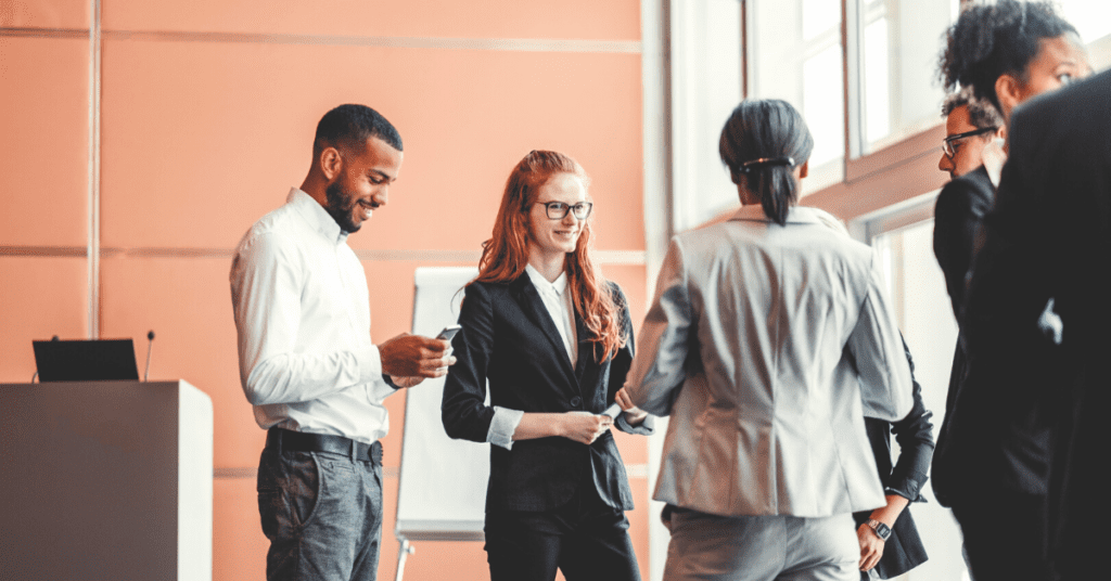 Sales reps talking to prospect at tradeshow