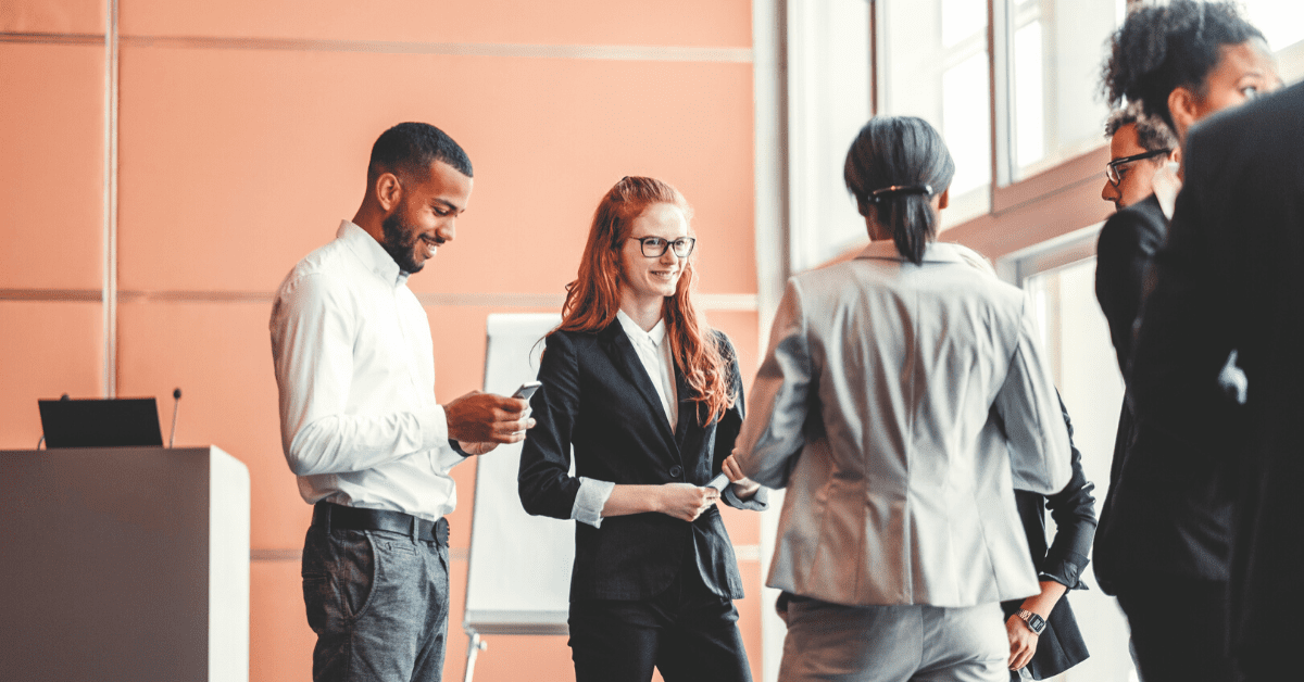 Sales reps talking to prospect at tradeshow